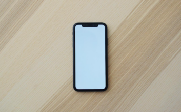 A mobile device on a wooden surface